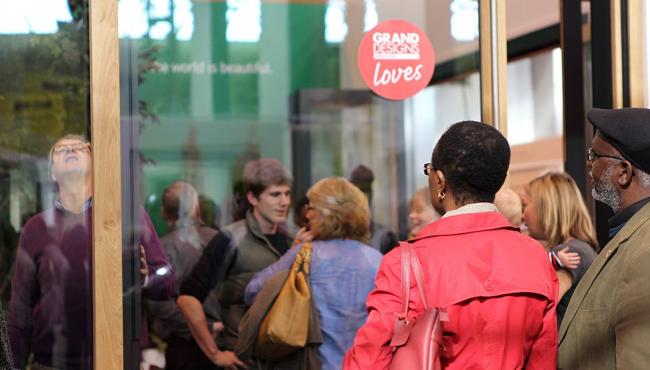 Visitors at Grand Designs Live viewing Centor bifold doors with fly screen and blind